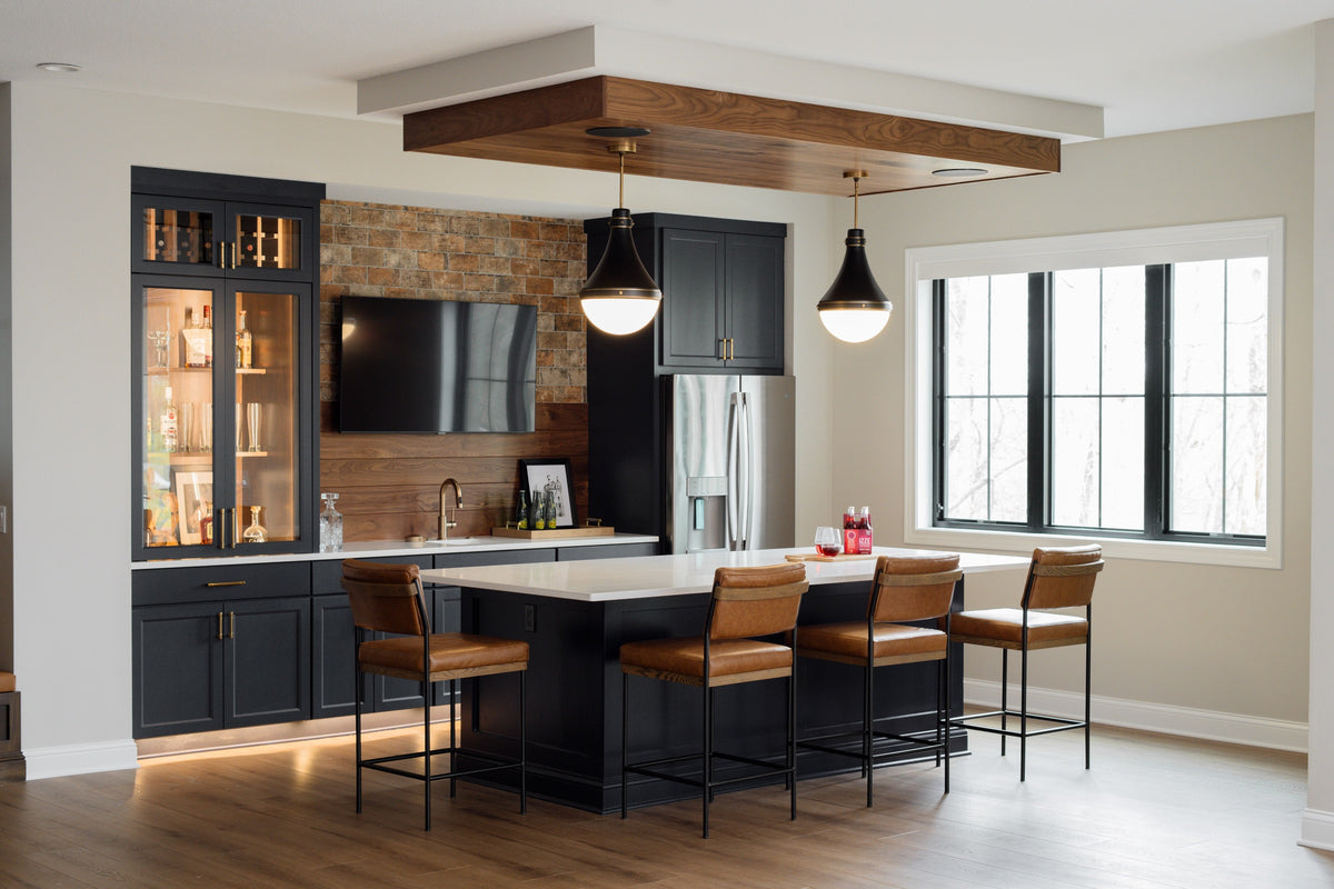 A kitchen in Van Meter with a black island and white quartz counter under a walnut plank ceiling.