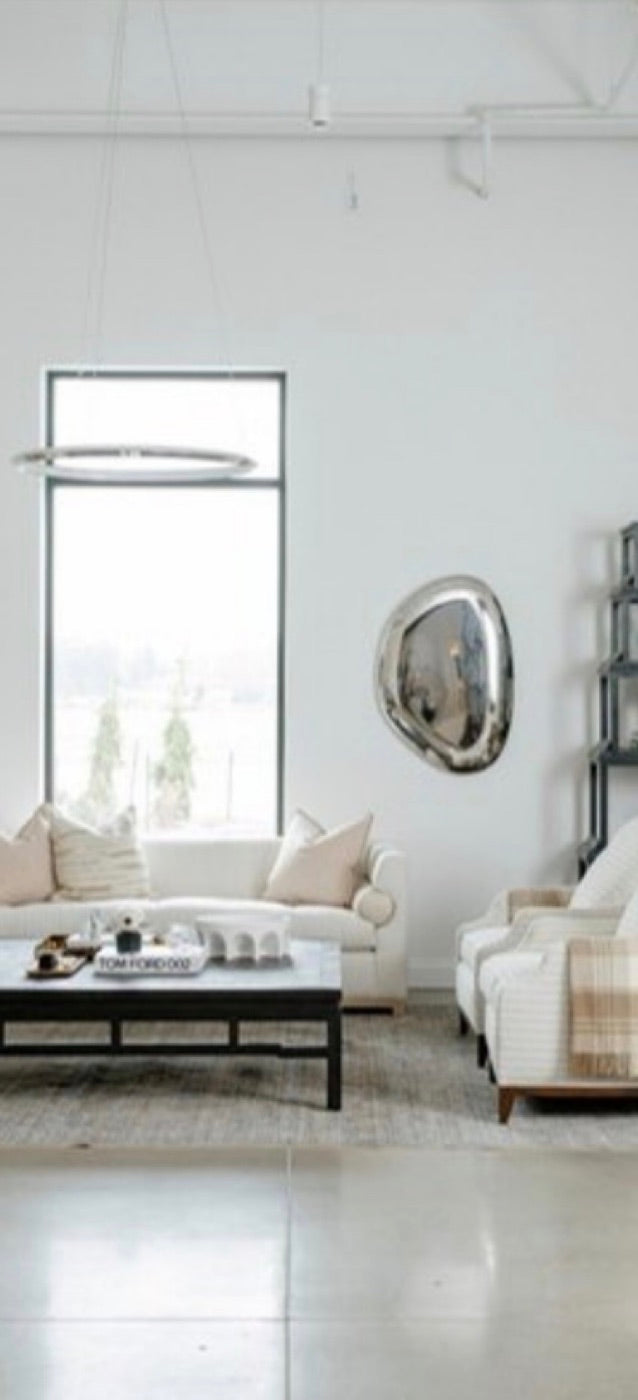 Inside the Jeid Studio showroom: a cream sofa, a dark coffee table and a round mirror